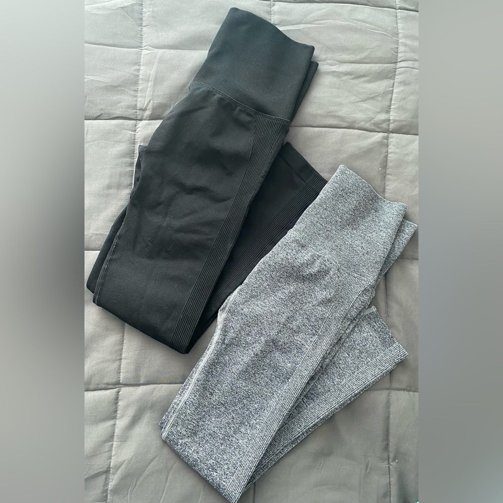Two pairs-medium womens workout leggings in black and gray.